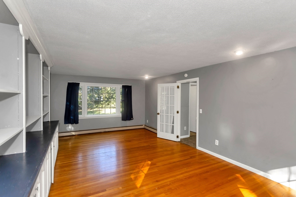 11 Longfellow Road Holyoke, MA 01040 - Photo 23 of 37 a view of an empty room with wooden floor and a window