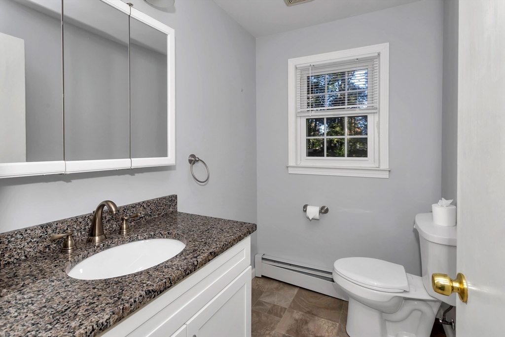 11 Longfellow Road Holyoke, MA 01040 - Photo 26 of 37 a bathroom with a granite countertop sink toilet and mirror
