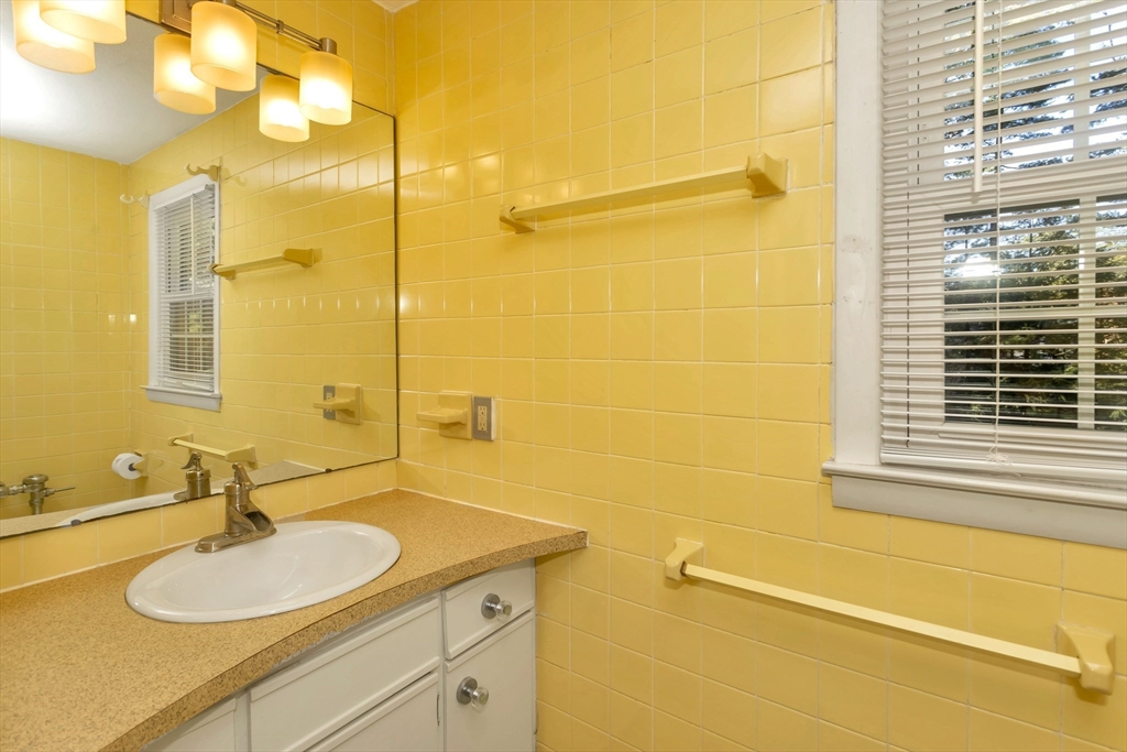 11 Longfellow Road Holyoke, MA 01040 - Photo 36 of 37 a bathroom with a granite countertop sink mirror and a shower