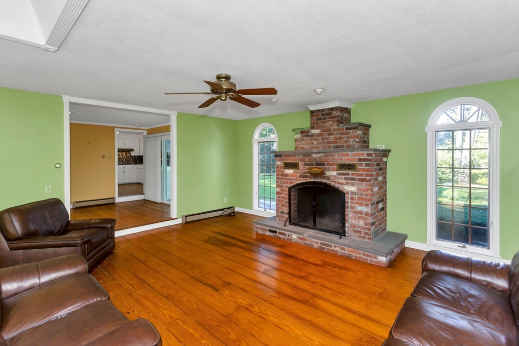 11 Longfellow Road Holyoke, MA 01040 - Photo 10 of 37 a living room with furniture a fireplace and a large window