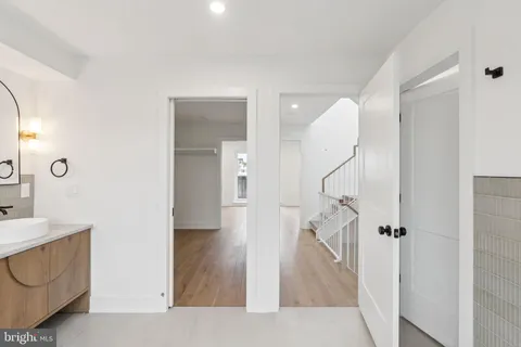 a view of a hallway with wooden floor and entryway