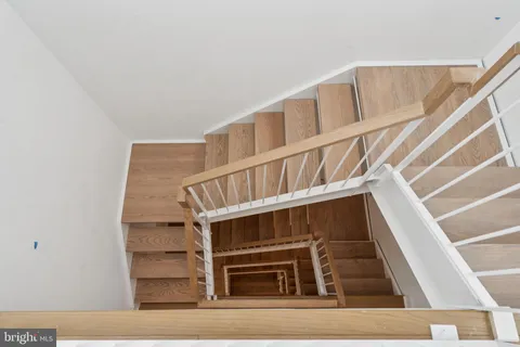 a view of staircase with white walls and a window