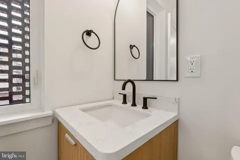a bathroom with a sink vanity and a mirror
