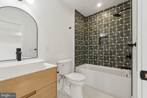 a bathroom with a toilet and a bathtub