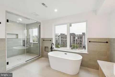 a bathroom with a bathtub and a shower