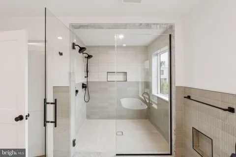 a bathroom with a granite countertop shower a toilet and a sink