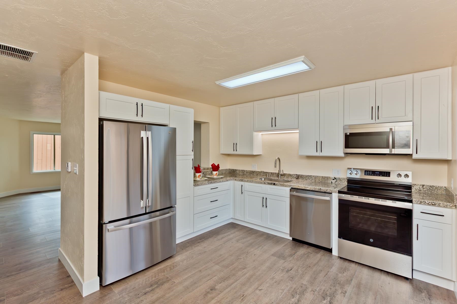 575-28 28 1/2 Road, Unit 44 Grand Junction, CO 81501 - Photo 6 of 39 a kitchen with granite countertop white cabinets and white appliances