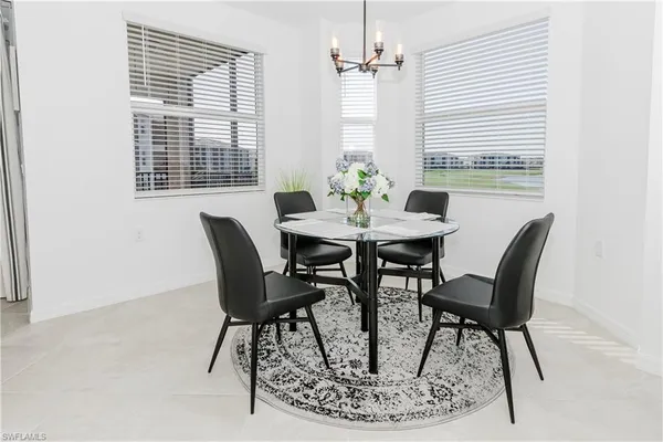a view of a dining room with furniture and window