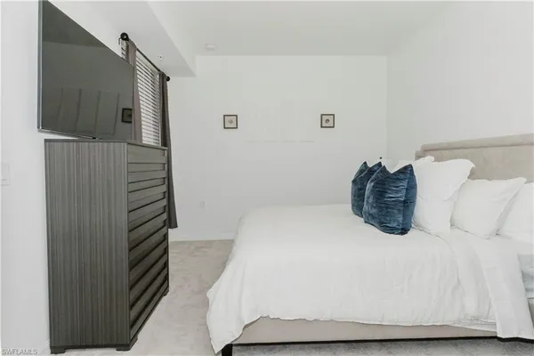 a bedroom with a bed and a walk in closet