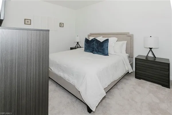 a bedroom with a bed and a cabinets
