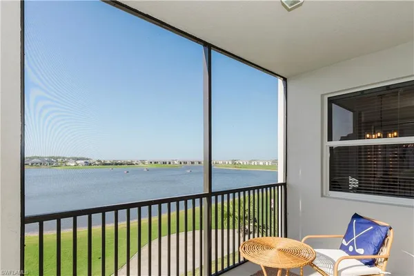a view of a balcony with chair and wooden floor