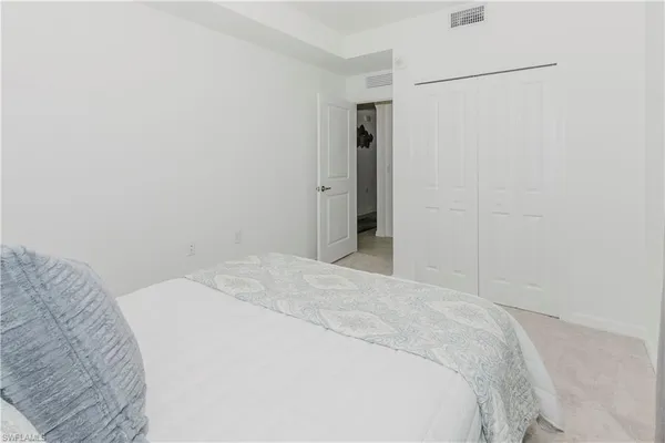 a bedroom with a bed and a cabinet