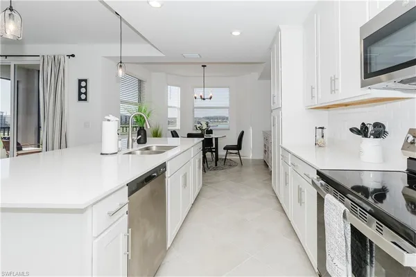 a kitchen with stove cabinets and dining table
