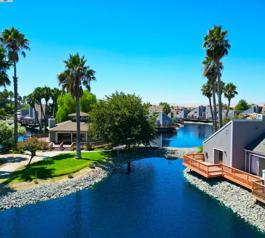 an aerial view of a house with swimming pool garden and patio