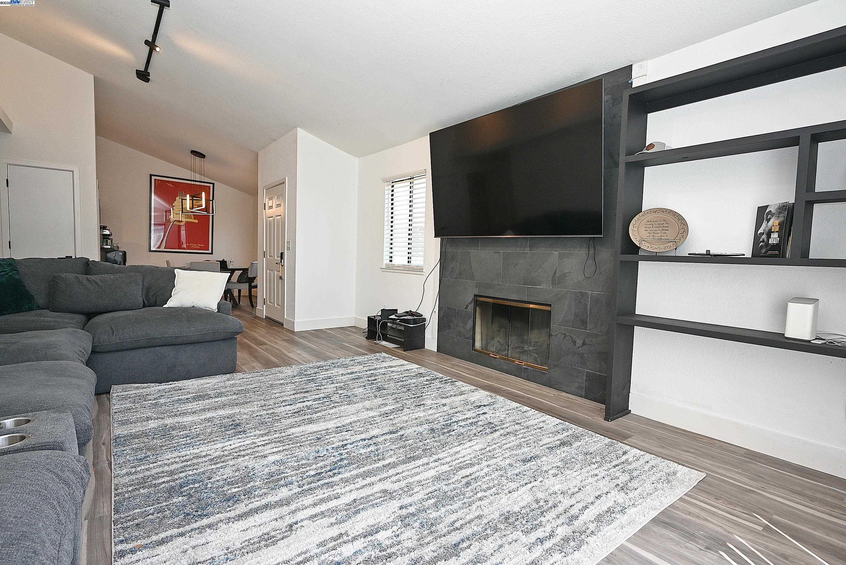 2073 Sand Point Road Discovery Bay, CA 94505 - Photo 30 of 40 a living room with furniture a flat screen tv and a fireplace