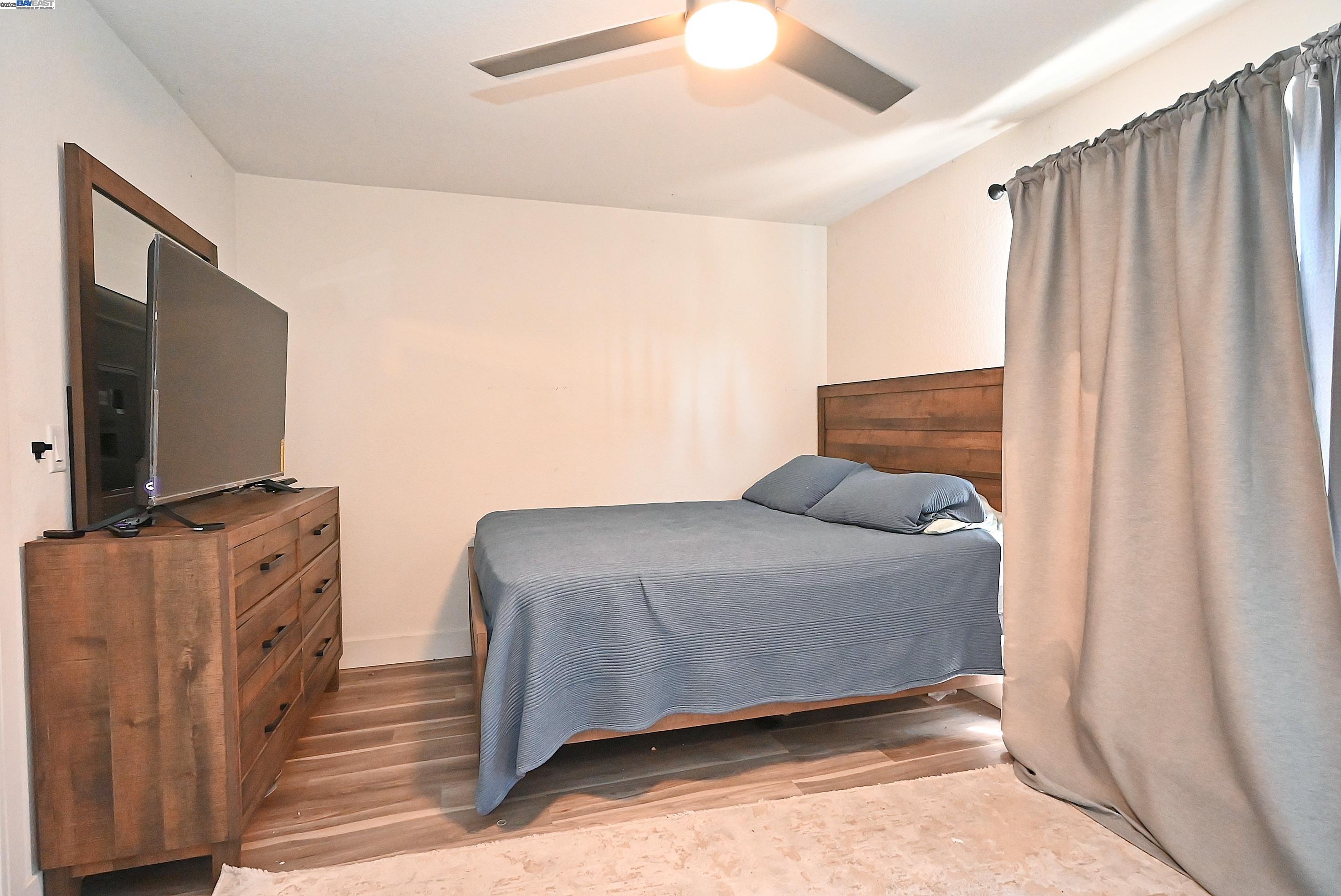 2073 Sand Point Road Discovery Bay, CA 94505 - Photo 31 of 40 a living room with furniture and a flat screen tv