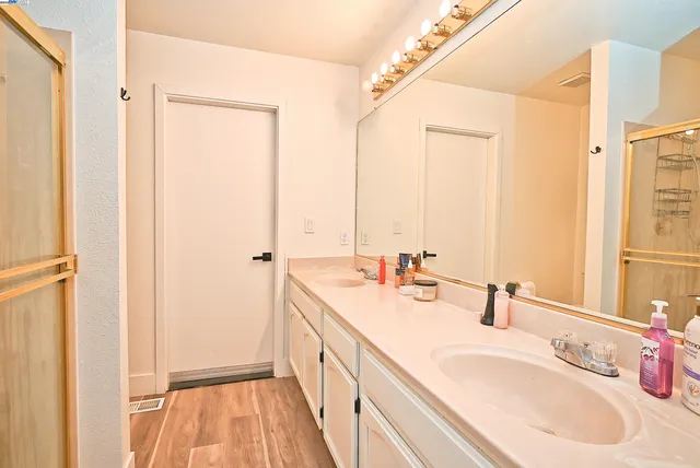a bathroom with a double vanity sink and mirror