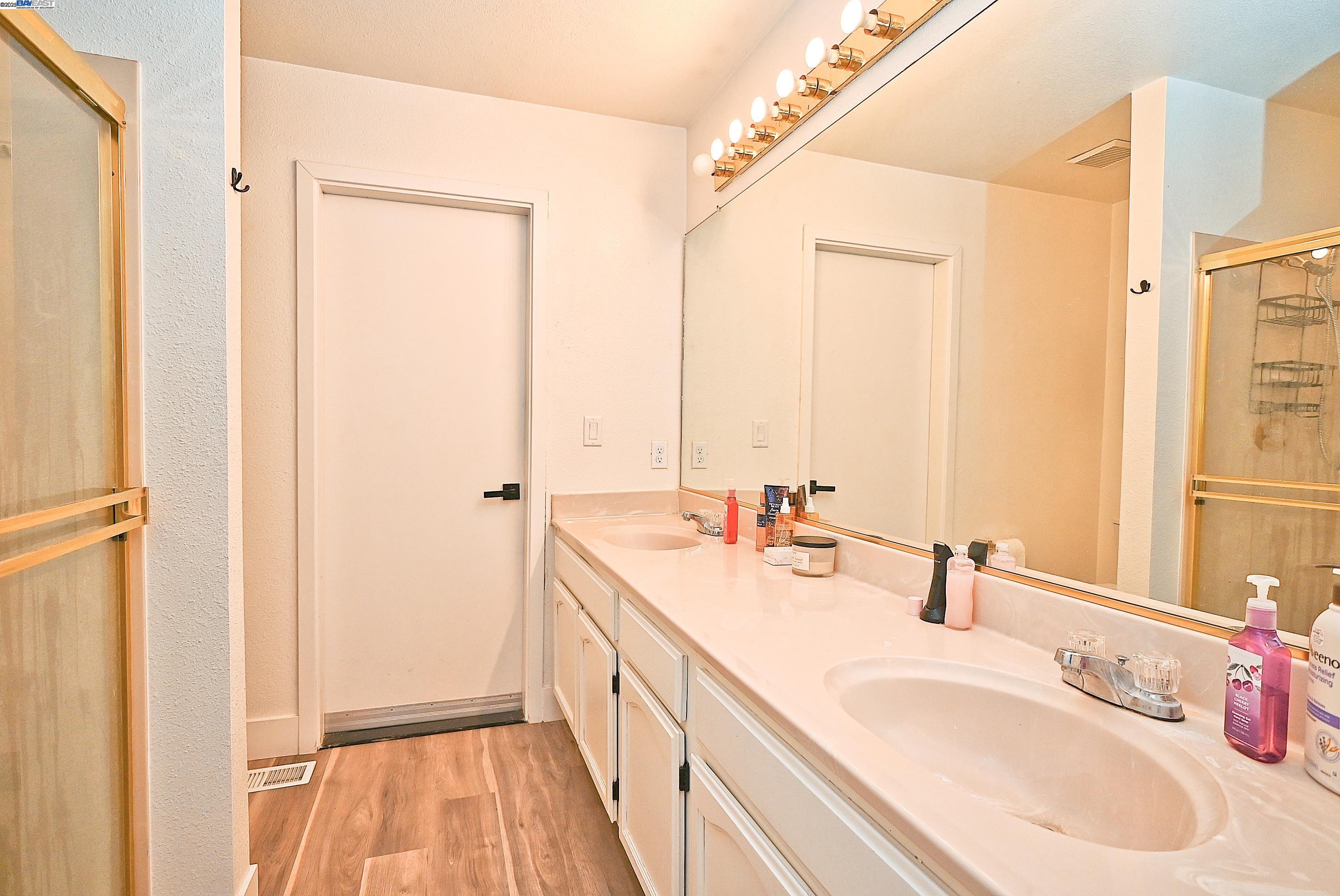 2073 Sand Point Road Discovery Bay, CA 94505 - Photo 33 of 40 a bathroom with a double vanity sink and mirror