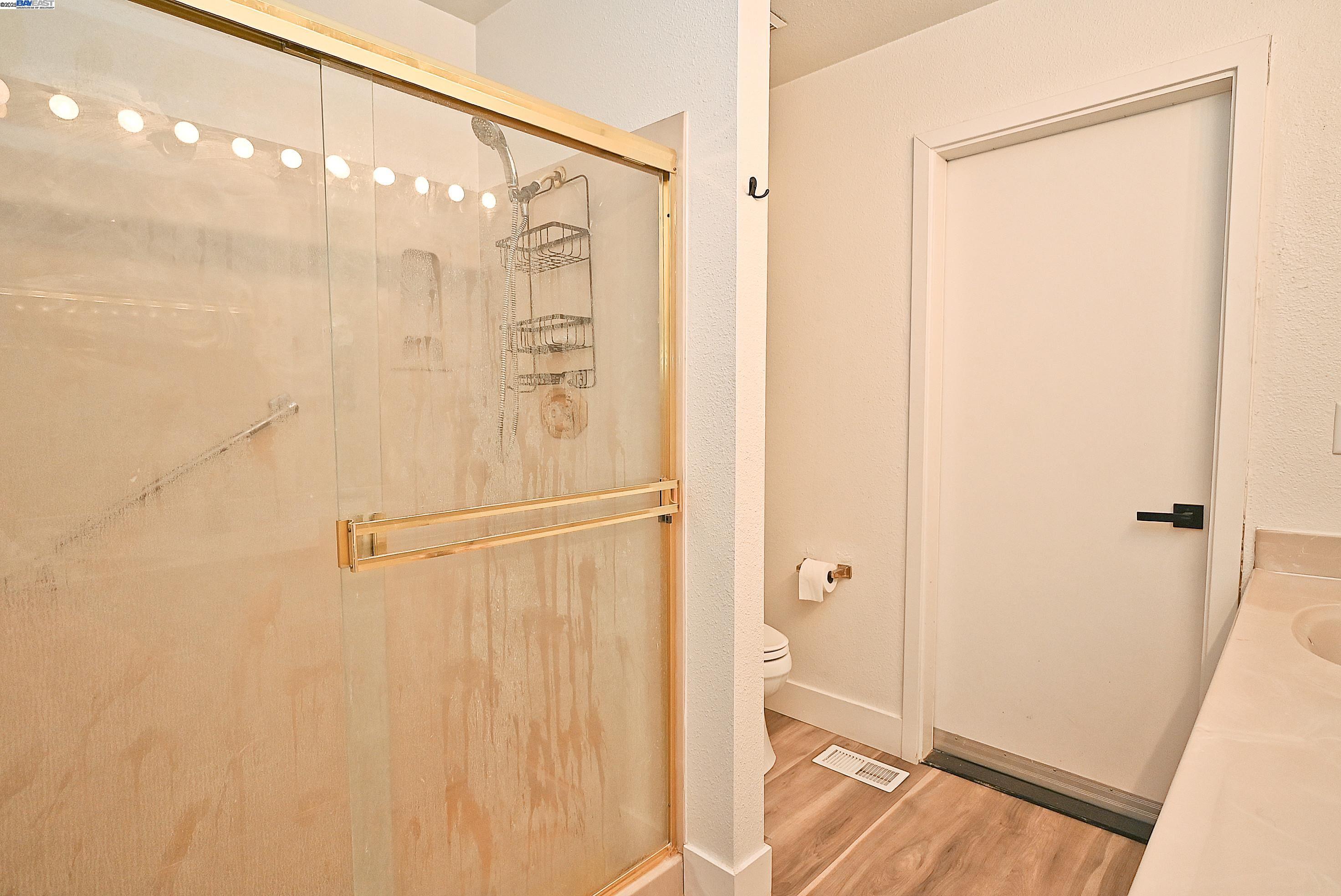 2073 Sand Point Road Discovery Bay, CA 94505 - Photo 34 of 40 a bathroom with a shower and a glass door