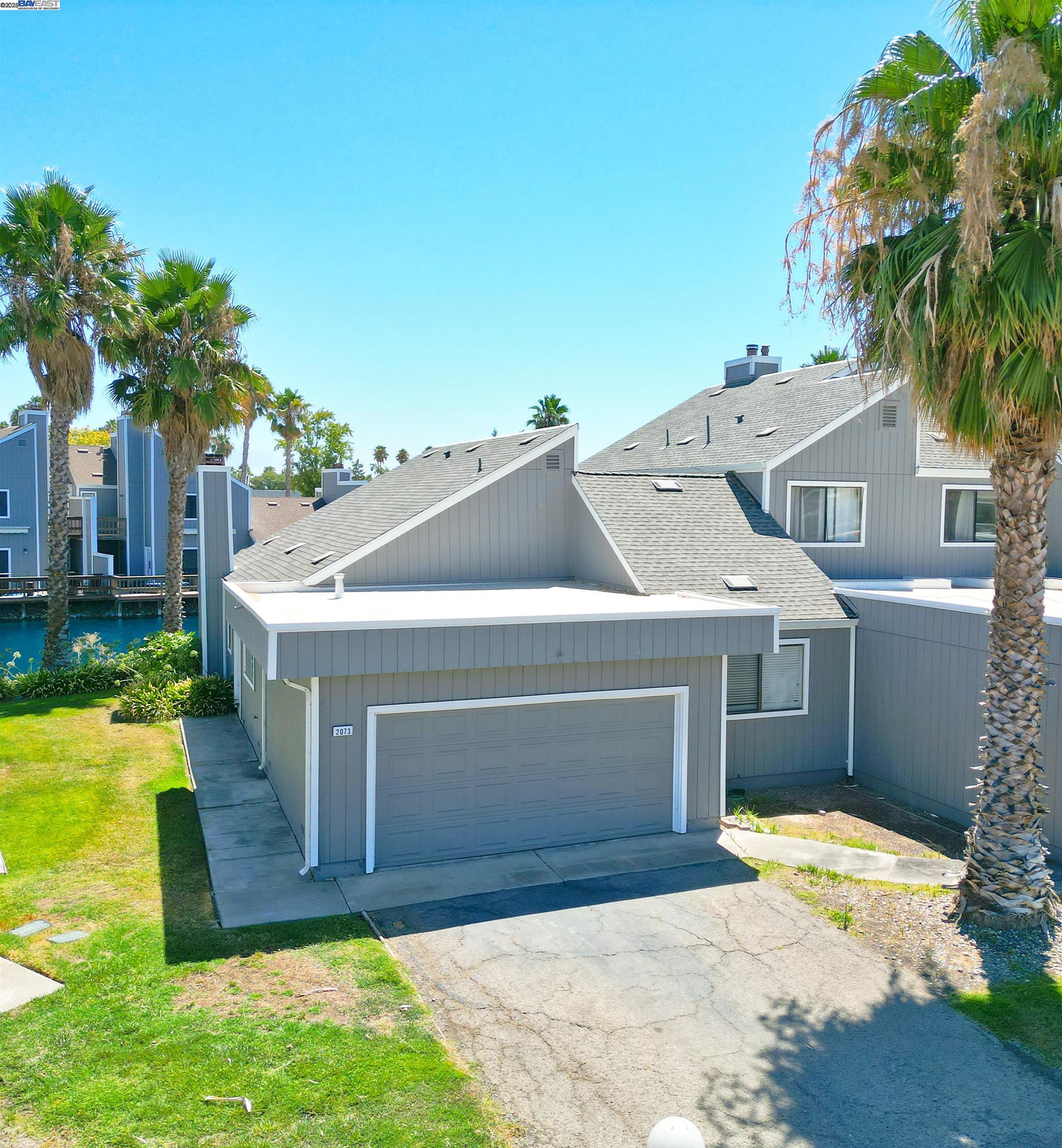 2073 Sand Point Road Discovery Bay, CA 94505 - Photo 10 of 40 a front view of a house with a yard