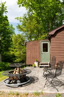 a view of a backyard with chairs and a patio