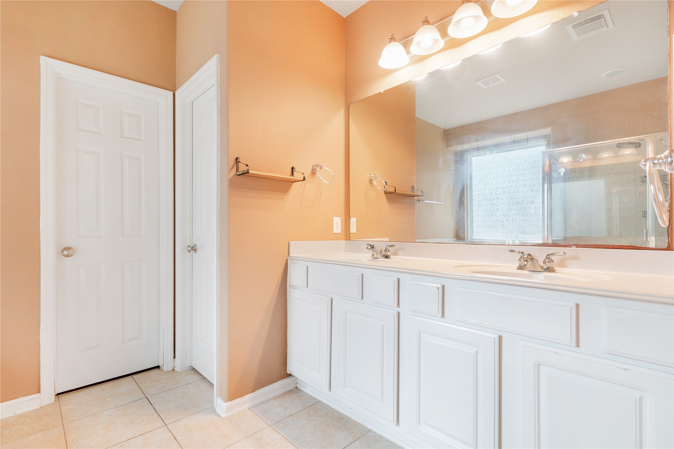 16622 Dover Mills Drive Spring, TX 77379 - Photo 14 of 30 a bathroom with a double vanity sink and a mirror