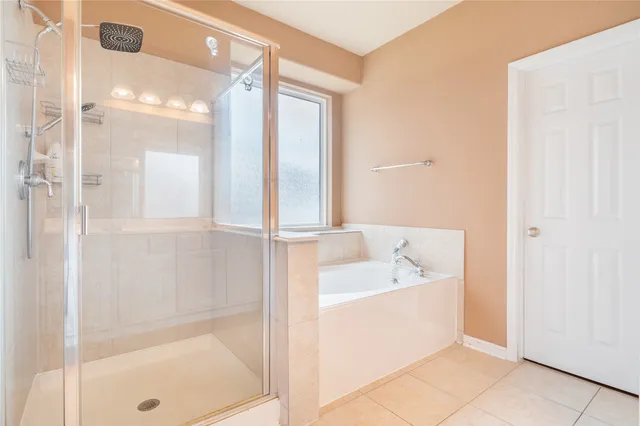 a bathroom with a tub shower and sink