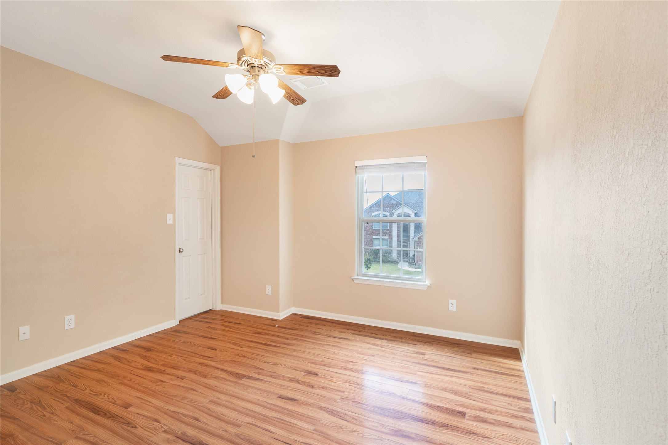 16622 Dover Mills Drive Spring, TX 77379 - Photo 19 of 30 an empty room with wooden floor fan and windows