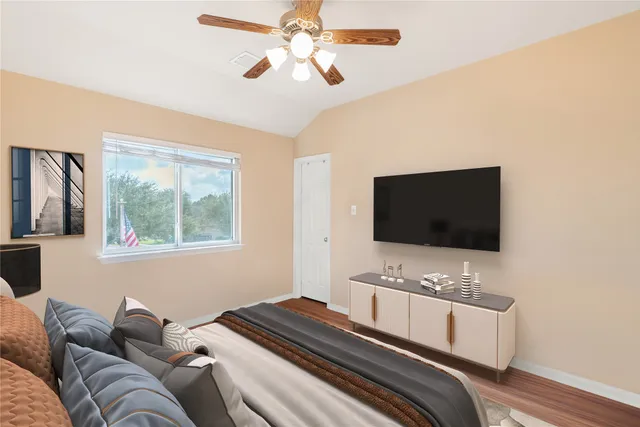 a bedroom with a bed and a flat screen tv