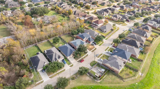 an aerial view of residential houses with outdoor space