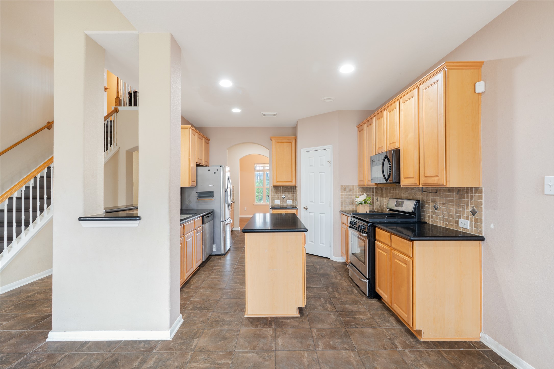 16622 Dover Mills Drive Spring, TX 77379 - Photo 7 of 30 a kitchen with stainless steel appliances granite countertop a stove top oven a refrigerator a sink and dishwasher