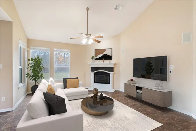 a living room with furniture a flat screen tv and a fireplace