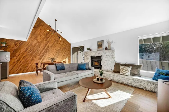 a living room with furniture a rug and a fireplace
