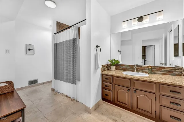 a bedroom with a bed and a lamp