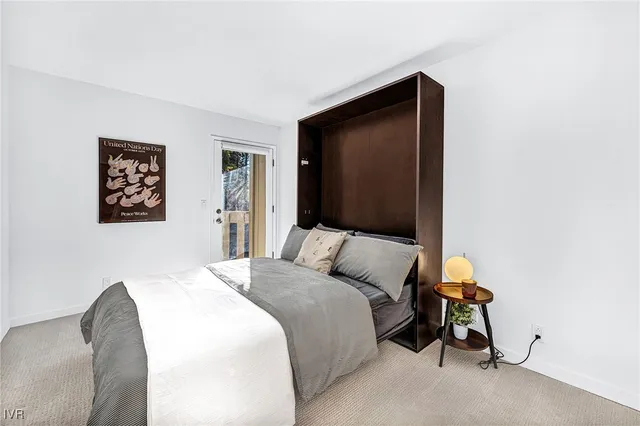 a spacious bathroom with a granite countertop sink a mirror and a shower