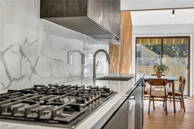 a view of a kitchen with wooden floor and furniture