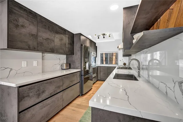 a view of kitchen with sink and wooden floor