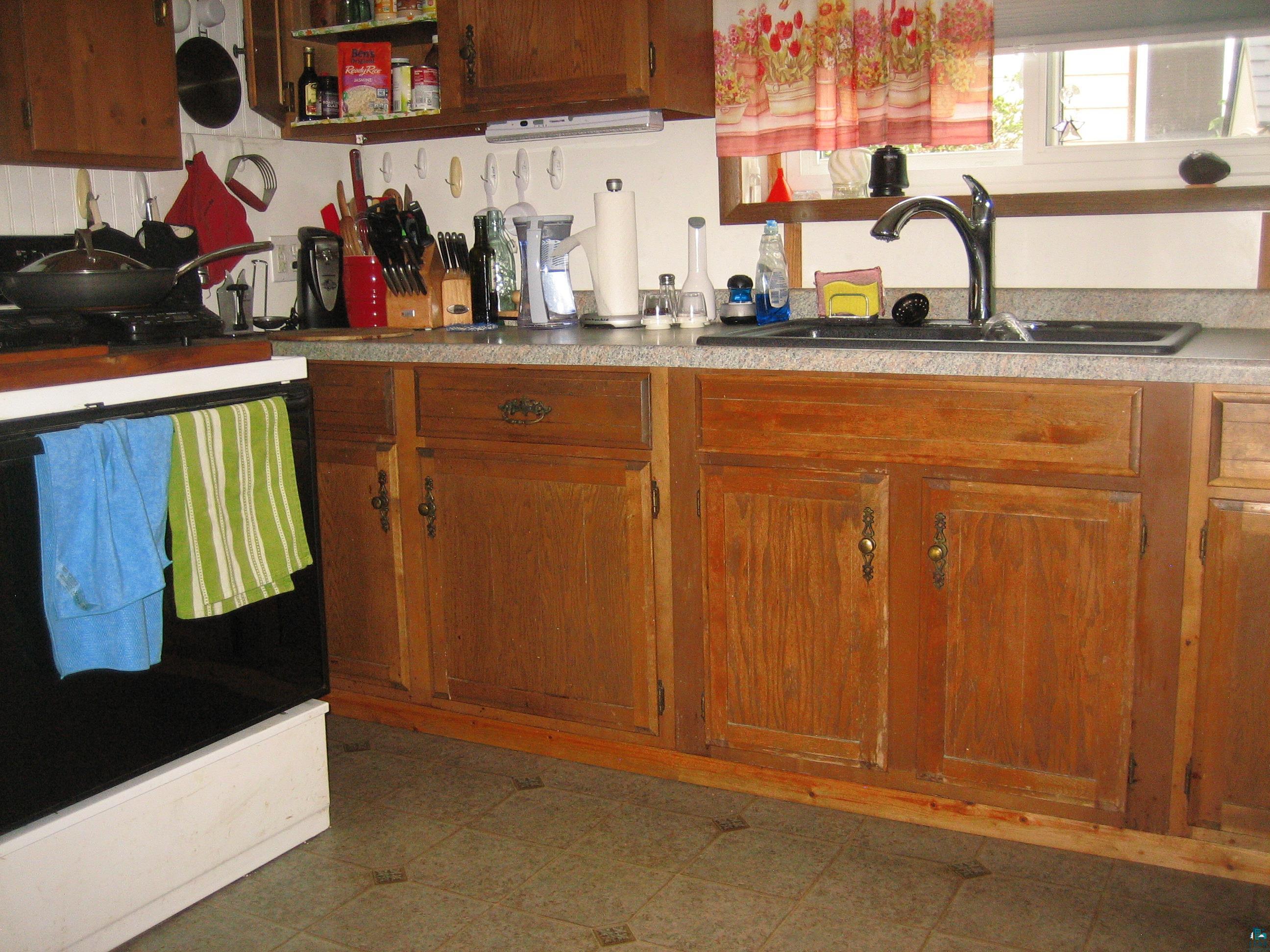 548 Front Street Winton, MN 55796 - Photo 6 of 17 Kitchen featuring range, sink, and dark tile patterned floors