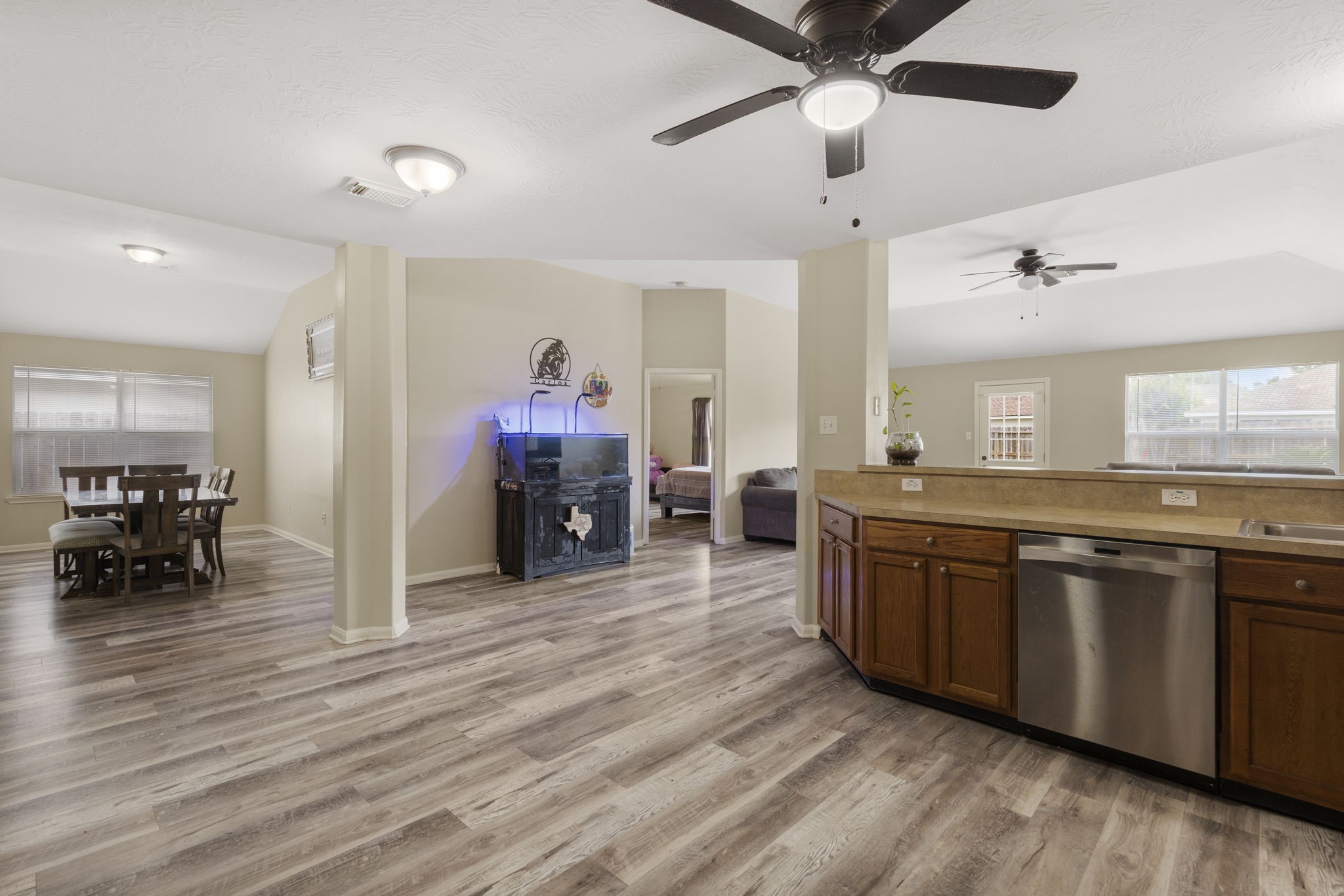 29106 Foxingham Circle Spring, TX 77386 - Photo 15 of 47 a large kitchen with stainless steel appliances granite countertop a oven a dining table and chairs with wooden floor