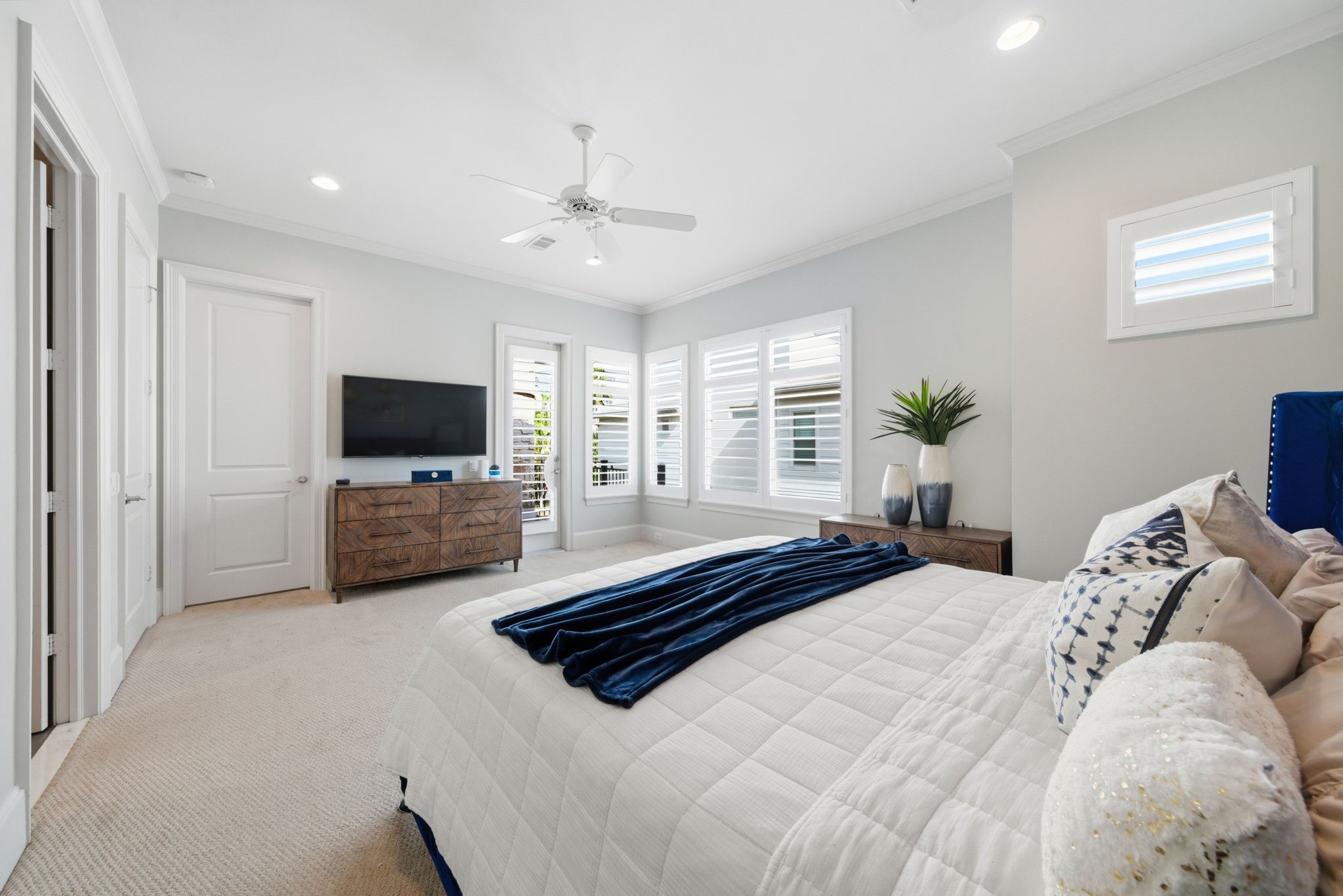 4915 Chenevert Street Houston, TX 77004 - Photo 23 of 41 Enjoy a private balcony with wood plank flooring and sleek iron railing, creating an inviting spot for morning coffee or peaceful evening relaxation. The contemporary stone accent wall adds visual interest, while views of the tranquil gated community give this outdoor space a unique sense of privacy and comfort.