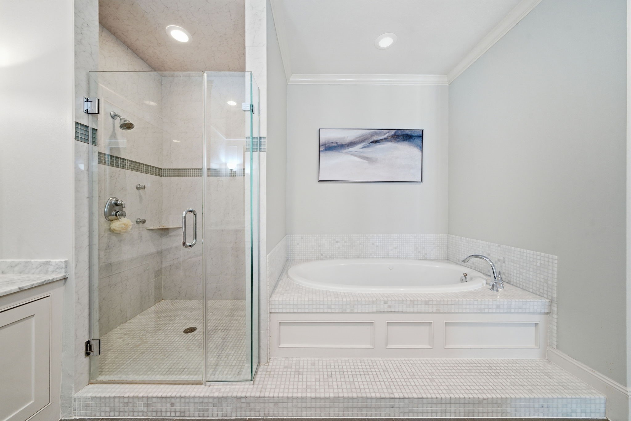 4915 Chenevert Street Houston, TX 77004 - Photo 27 of 41 Expansive walk-in closet features abundant built-in shelving, dual chest-style drawer towers, and versatile hanging space for wardrobe organization. Thoughtfully designed for both style and function, this closet offers generous storage to complement the primary suite’s contemporary comfort.