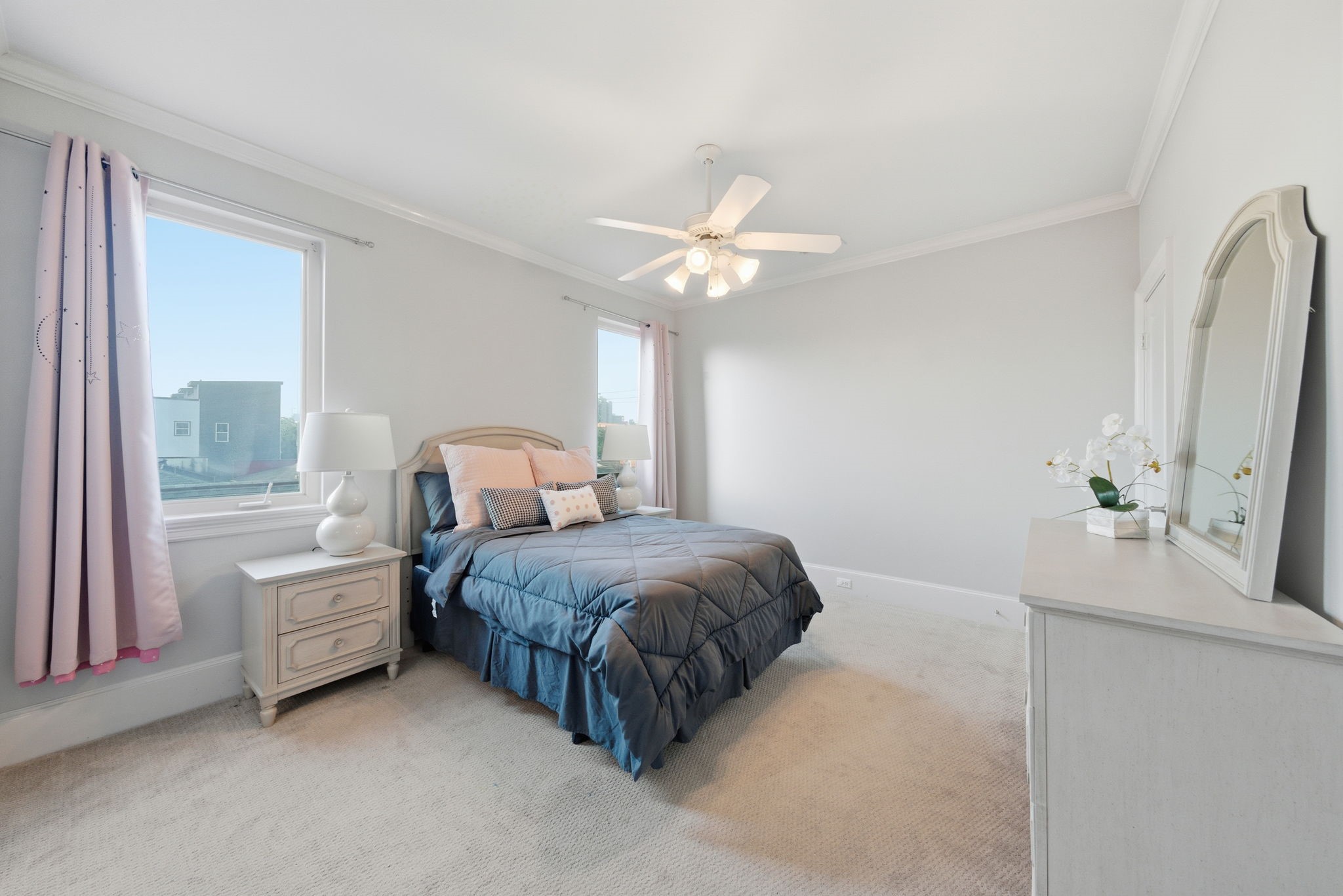 4915 Chenevert Street Houston, TX 77004 - Photo 32 of 41 Generous built-in cabinetry and a lengthy marble-topped vanity highlight this full bathroom, offering ample storage and a clean, contemporary design. The separate tub-and-shower combination makes it ideal for use as a guest or secondary bath, blending functionality with comfort.