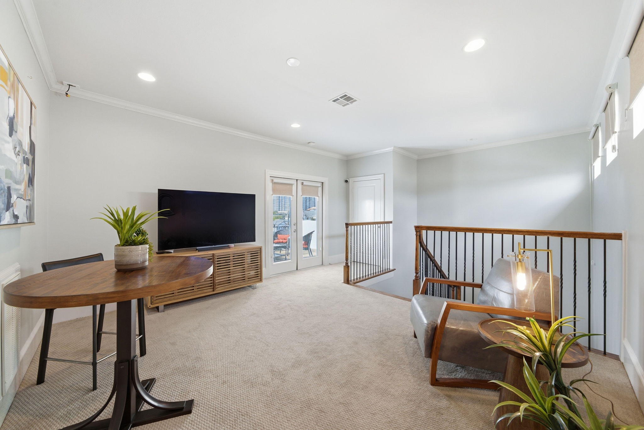 4915 Chenevert Street Houston, TX 77004 - Photo 34 of 41 Positioned near the upper landing, this bright game room features plush carpeting, recessed lighting, and generous space for relaxing, games, or workspace. The versatile layout easily accommodates media viewing or entertaining, offering a contemporary retreat on the top floor.