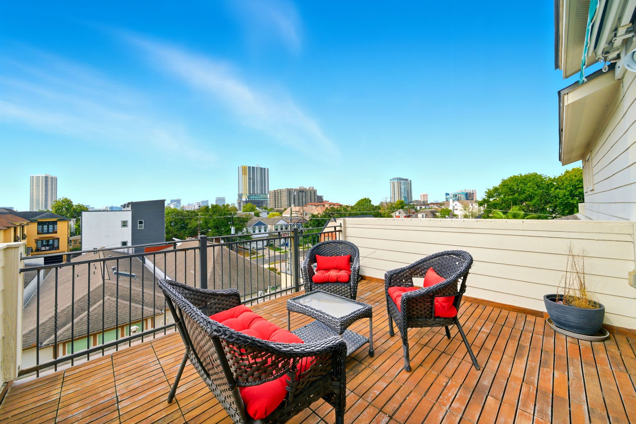 4915 Chenevert Street Houston, TX 77004 - Photo 36 of 41 Elevate everyday living on this private rooftop deck featuring durable wood plank flooring, a stylish seating area, and sweeping urban skyline views. Enjoy serene mornings or lively evenings in this low-maintenance outdoor retreat within a coveted gated enclave in the Rice/Museum District.