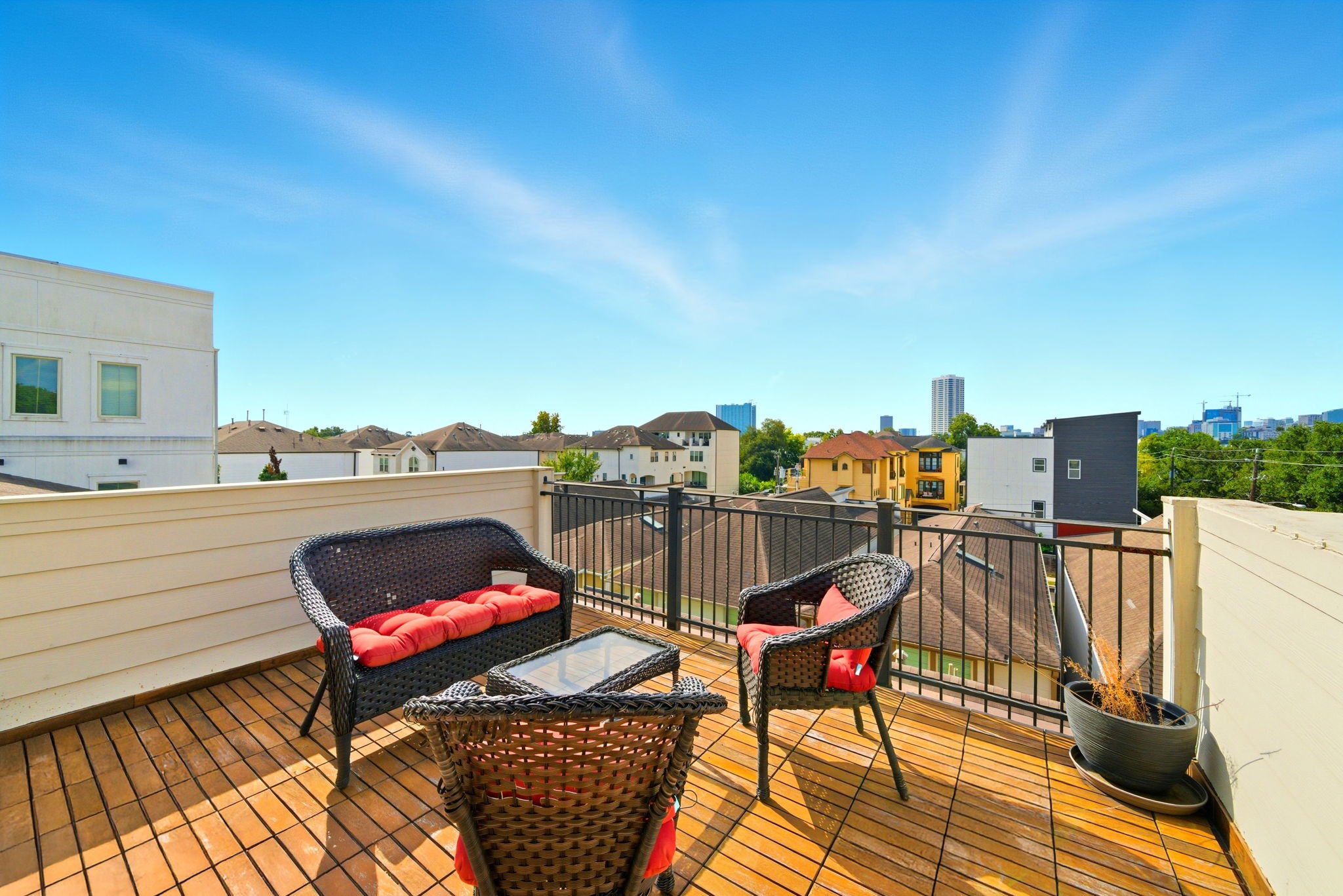 4915 Chenevert Street Houston, TX 77004 - Photo 37 of 41 Low-maintenance paved patio is accented by a modern spiral staircase for convenient upper-level access. This private outdoor space is ideal for practical needs and includes energy-efficient HVAC units while maintaining separation from neighbors with secure fencing.