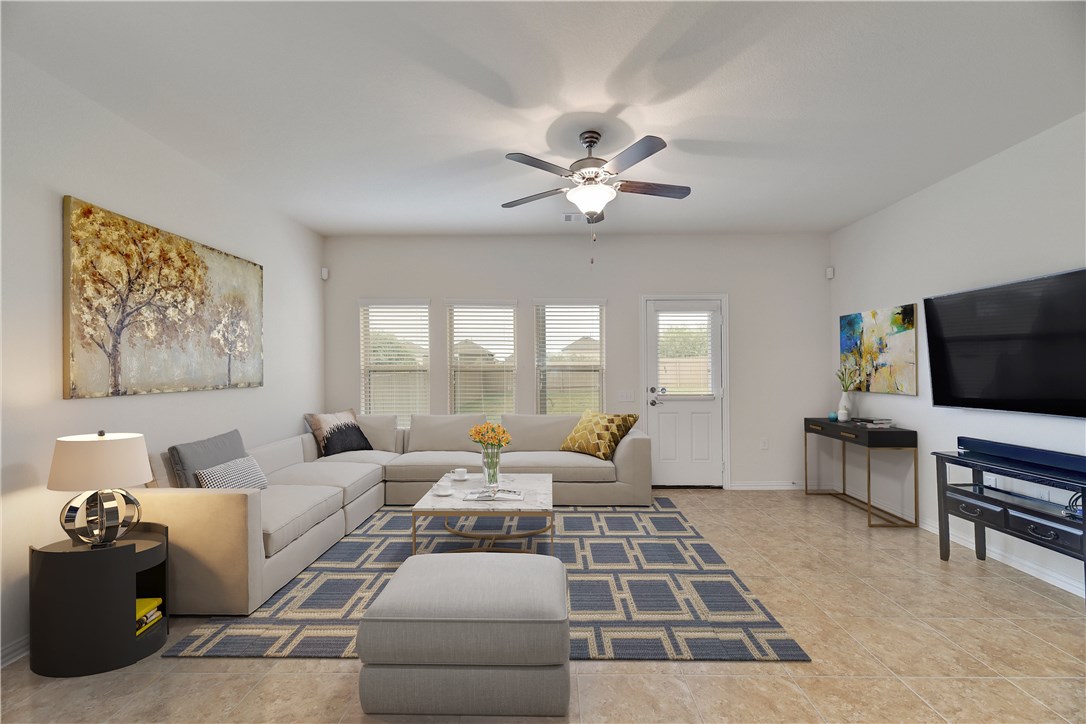 7100 Vail Ridge Street Austin, TX 78744 - Photo 1 of 1 a living room with furniture and a flat screen tv