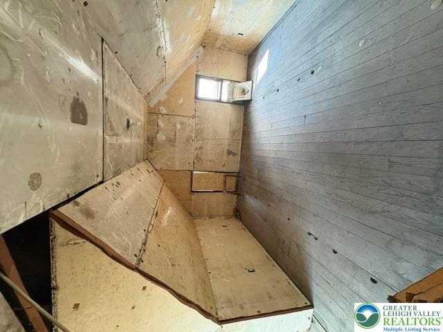 581 Mauch Chunk Road Palmerton, PA 18071 - Photo 22 of 27 Sloped ceilings and unfinished wood surfaces await transformation in this attic space.