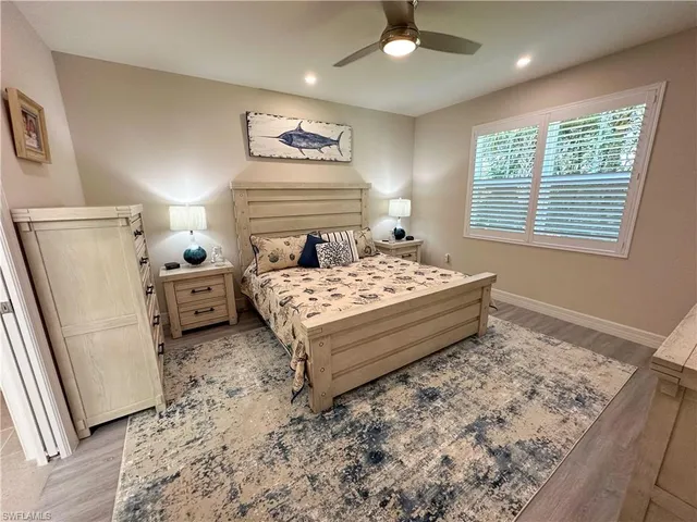 a bedroom with a bed and a refrigerator