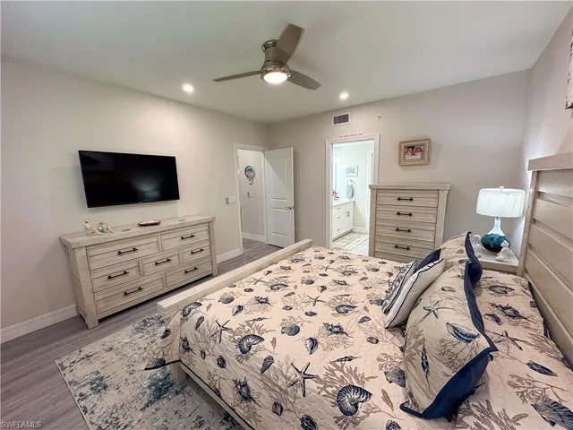 a bedroom with a bed and flat screen tv