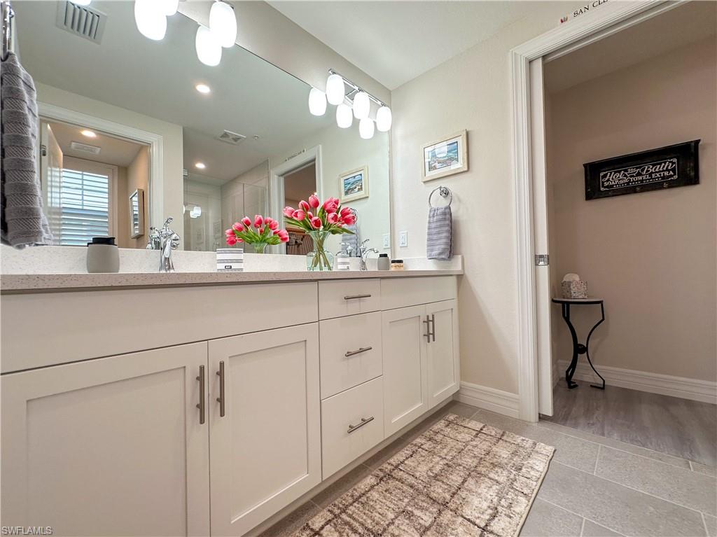 250 Indies Drive East, Unit 101 Naples, FL 34114 - Photo 15 of 49 a kitchen with cabinets and window